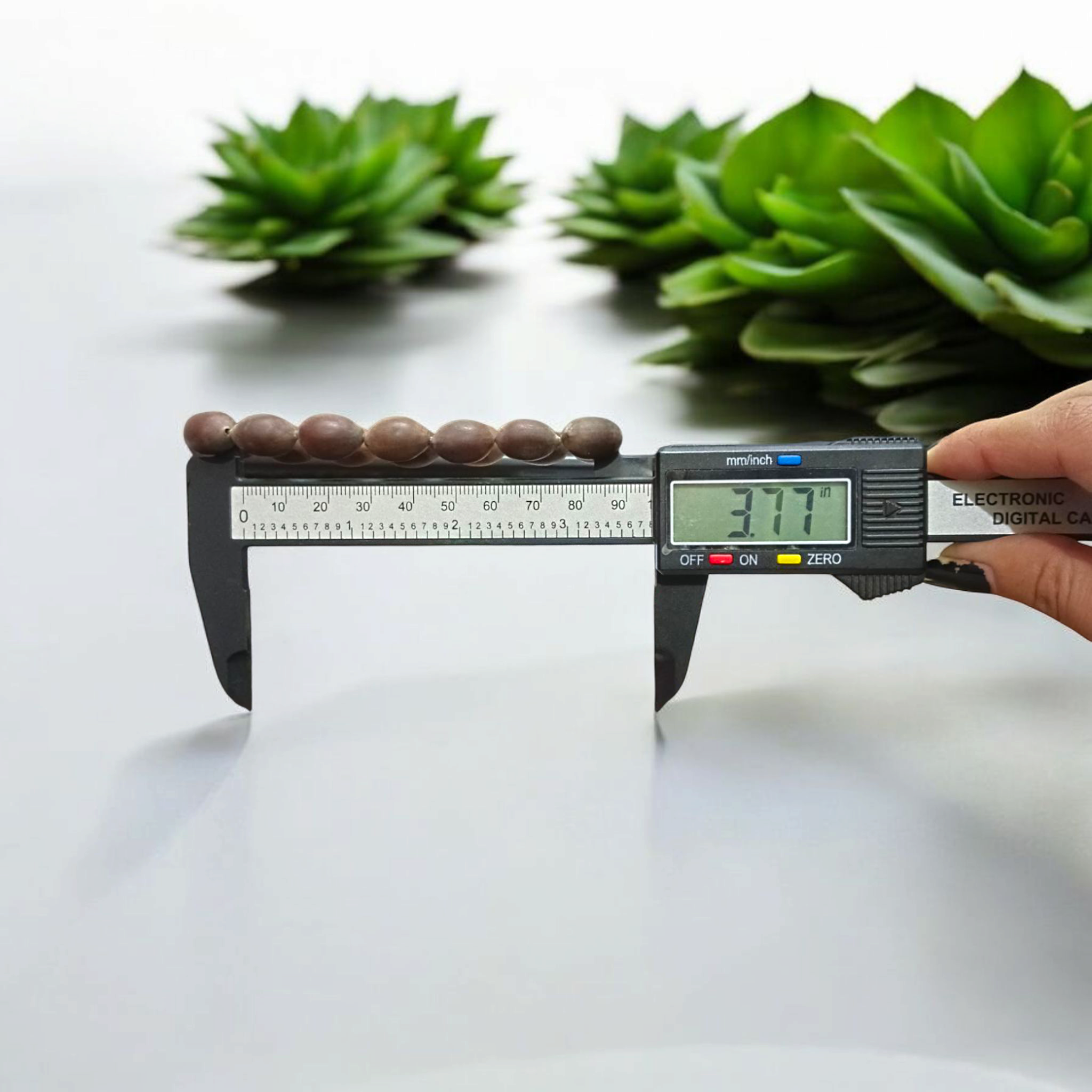 Image of Natural Kamal Gutta Bracelet made from 100% Original Lotus Seeds with Lab Certificate shown on a wrist for spiritual use