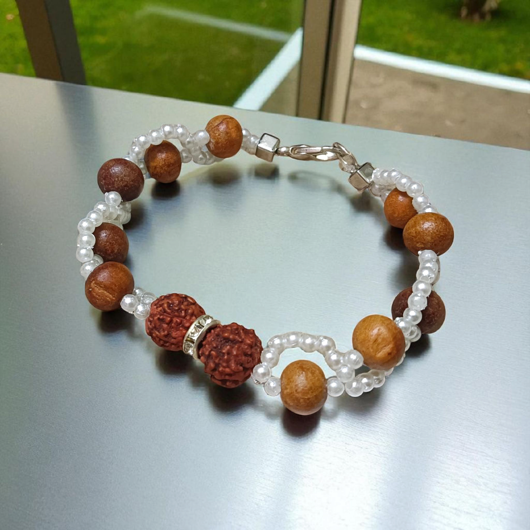 Image of Natural Rudraksha and Sandalwood Bracelet with lab-certified beads, used for energy balancing, protection, and spiritual well-being
