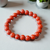Image of a Natural Red Jasper Bracelet with 8mm polished beads, stretchable cord, and lab-certified gemstone design