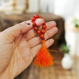 Image of a Natural Red Jasper Finger Mala with 8mm polished beads and a compact, portable design