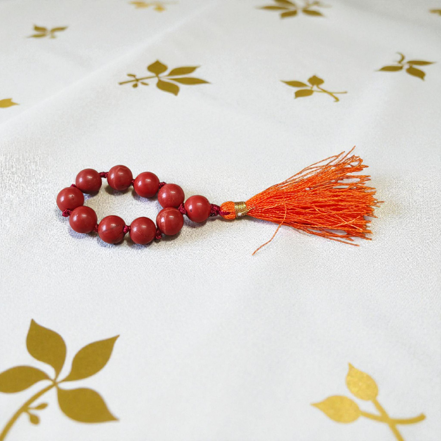 Image of a Natural Red Jasper Finger Mala with 8mm polished beads and a compact, portable design