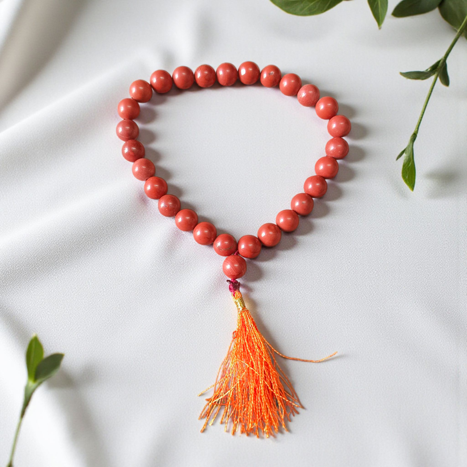 Image of a Natural Red Jasper Mala with 27+1 beads, featuring 8mm polished red gemstones and a spiritual tassel