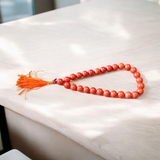 Image of a Natural Red Jasper Mala with 27+1 beads, featuring 8mm polished red gemstones and a spiritual tassel