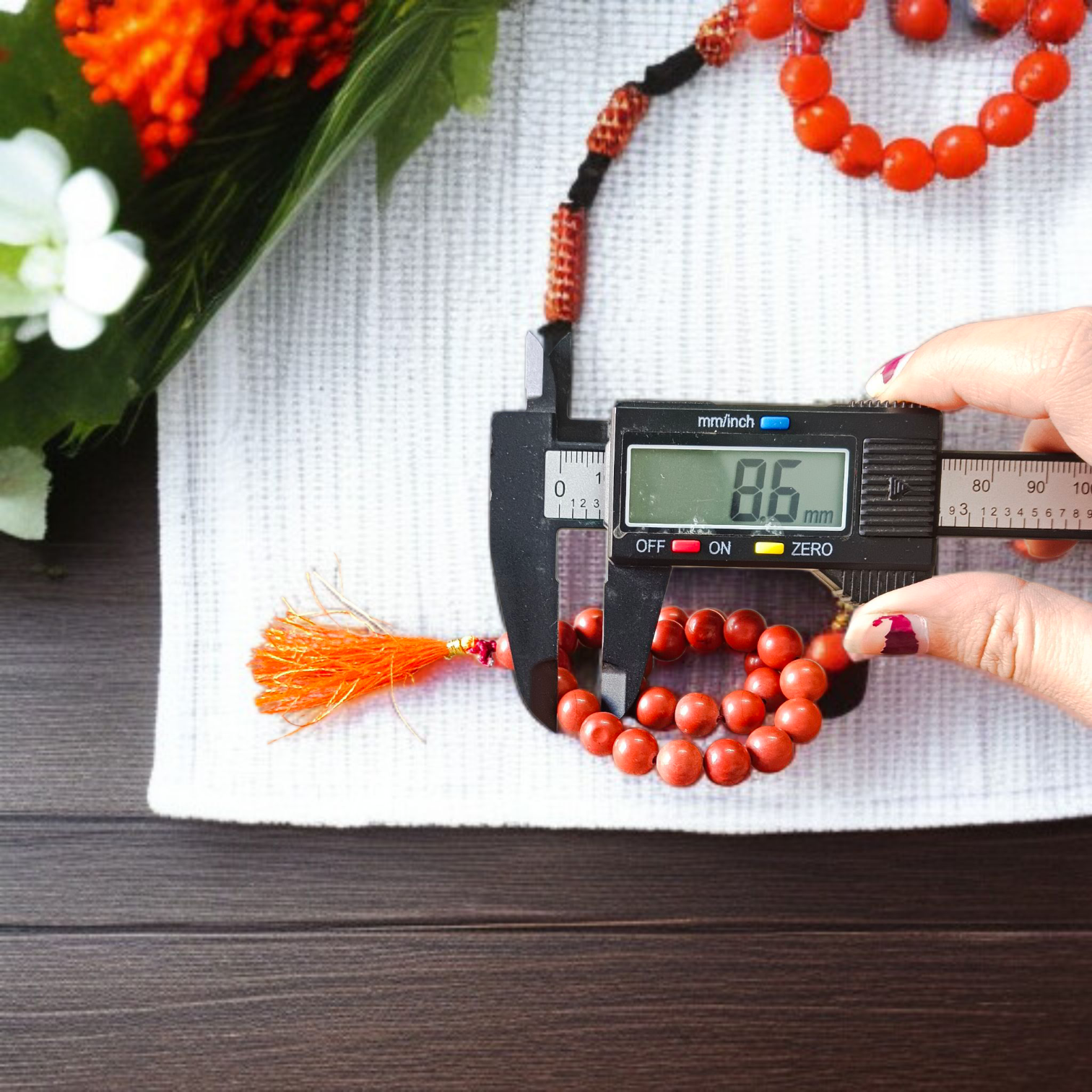 Image of a Natural Red Jasper Mala with 27+1 beads, featuring 8mm polished red gemstones and a spiritual tassel