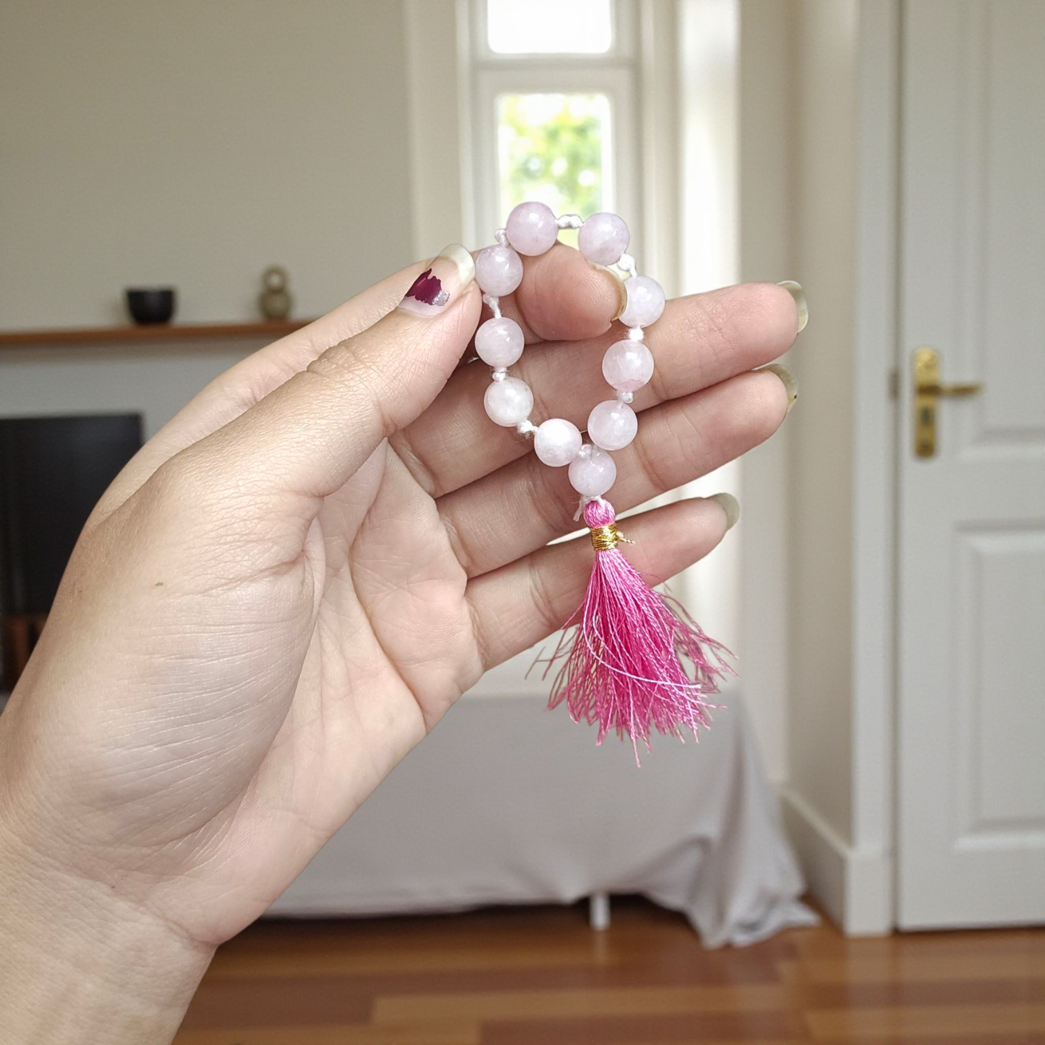 Image of a Natural Rose Quartz Finger Mala with 9+1 lab-certified 8mm beads, designed for meditation, peace, and emotional healing