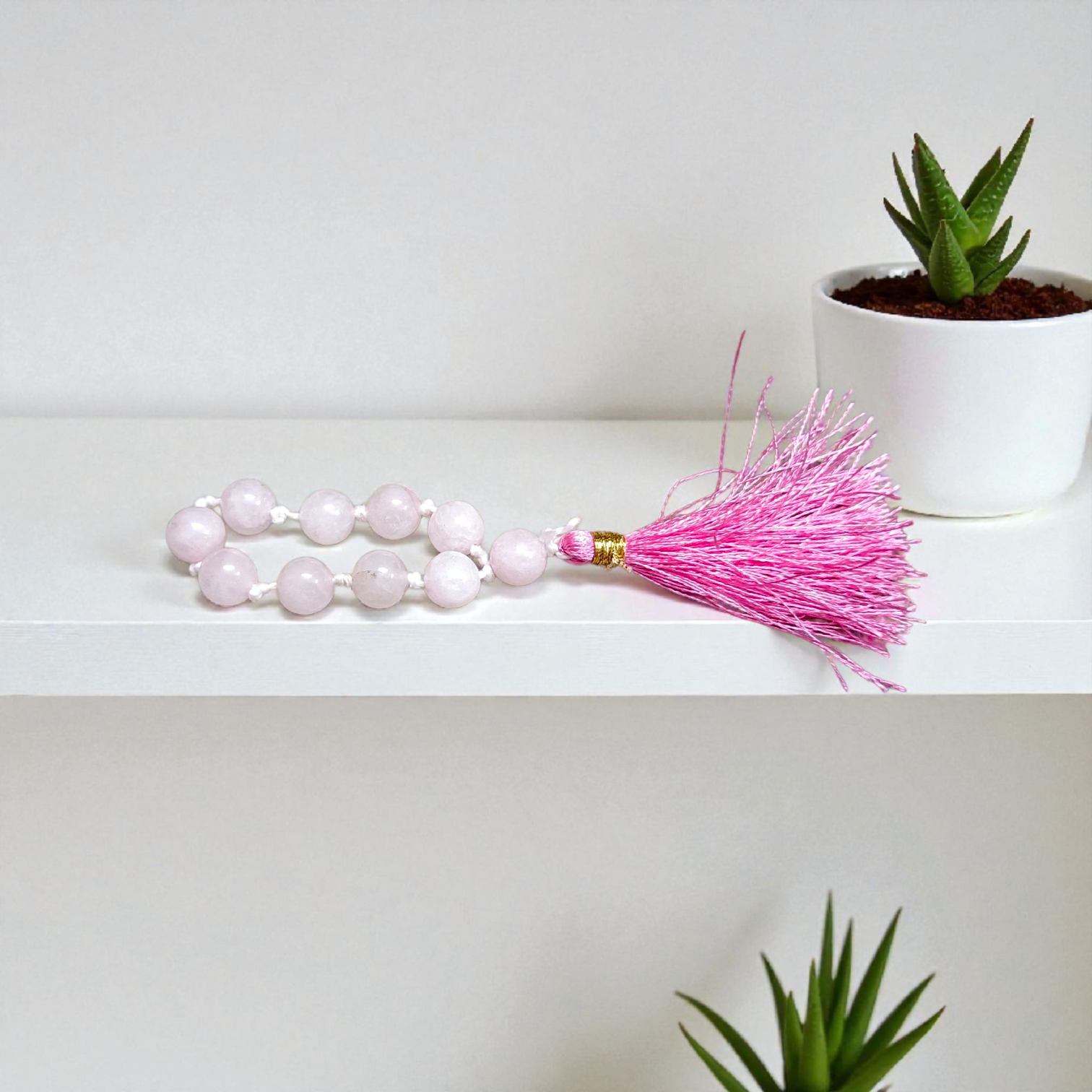 Image of a Natural Rose Quartz Finger Mala with 9+1 lab-certified 8mm beads, designed for meditation, peace, and emotional healing