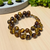 Image of a Natural Tiger Eye Bracelet made with polished 7mm lab-certified beads, designed for attracting good luck, wealth, and spiritual protection