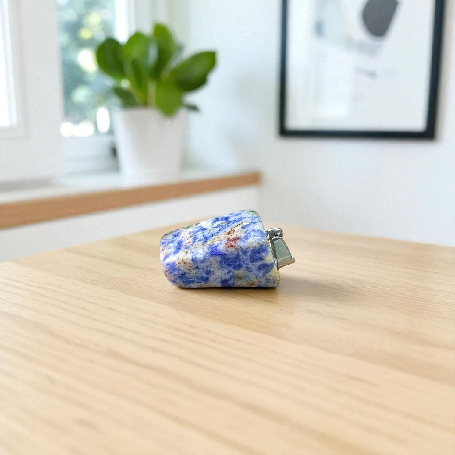 Image of a deep blue Lapis Lazuli Pendant with shimmering golden flecks, attached to a white metal chain – ideal for daily wear and spiritual benefits