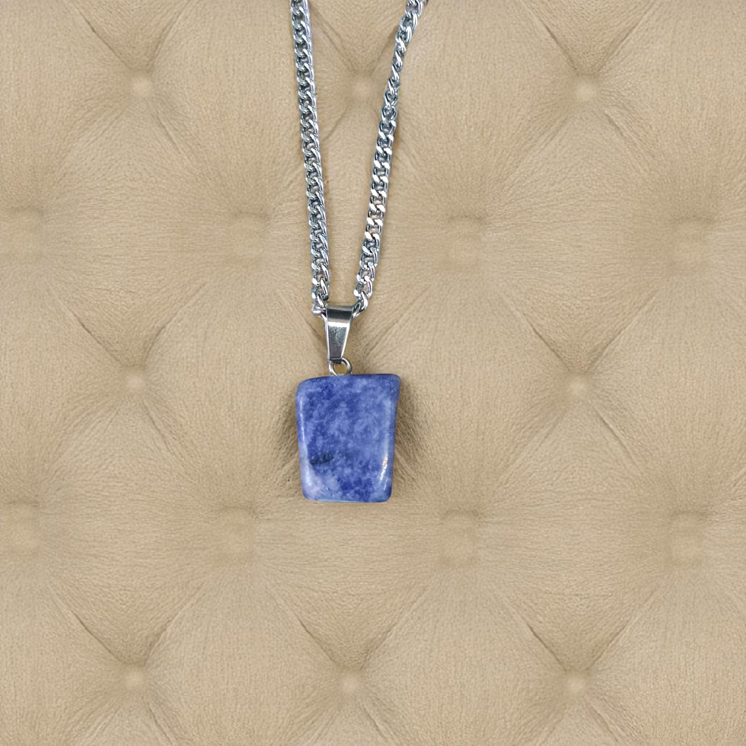 Image of a deep blue Lapis Lazuli Pendant with shimmering golden flecks, attached to a white metal chain – ideal for daily wear and spiritual benefits