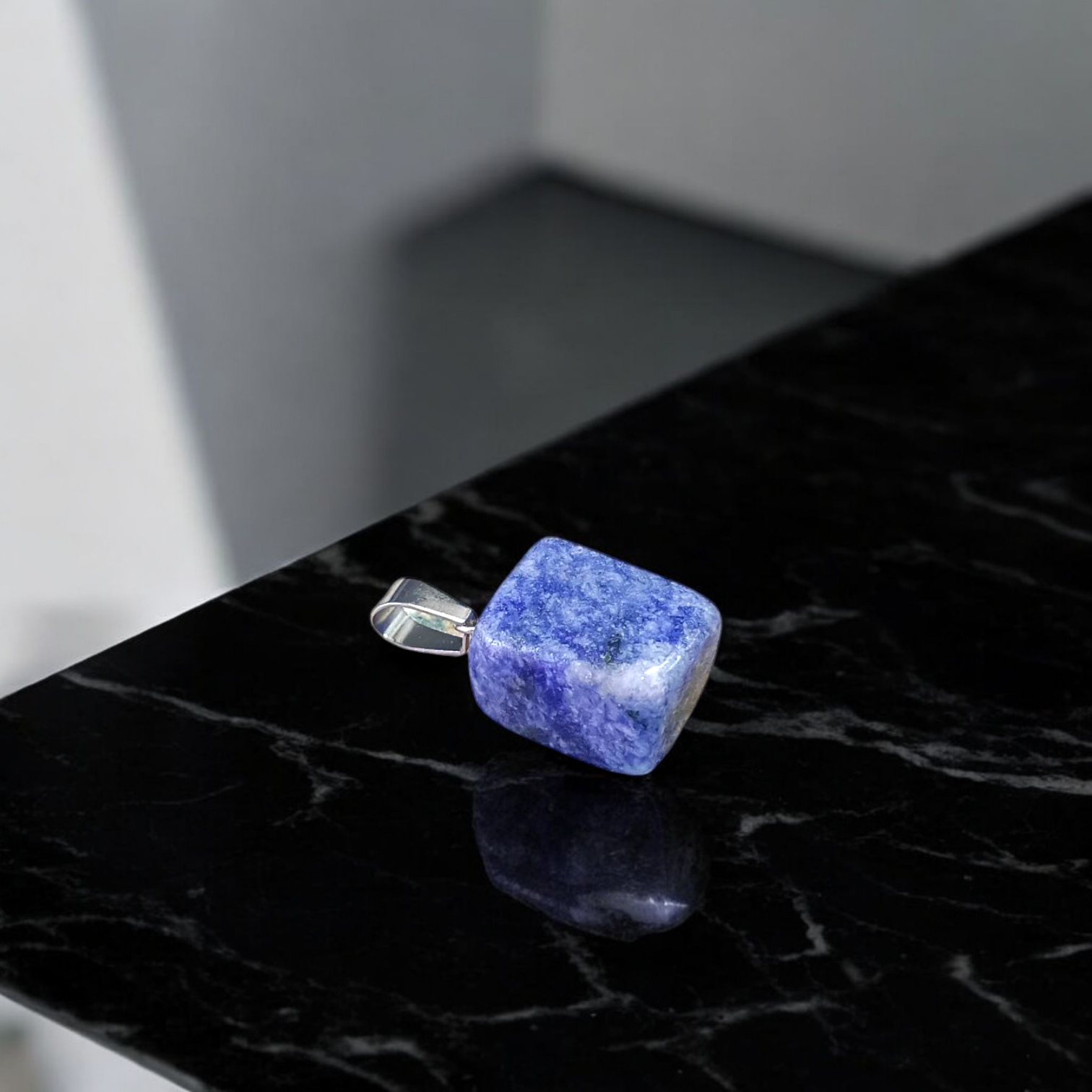 Image of a deep blue Lapis Lazuli Pendant with shimmering golden flecks, attached to a white metal chain – ideal for daily wear and spiritual benefits