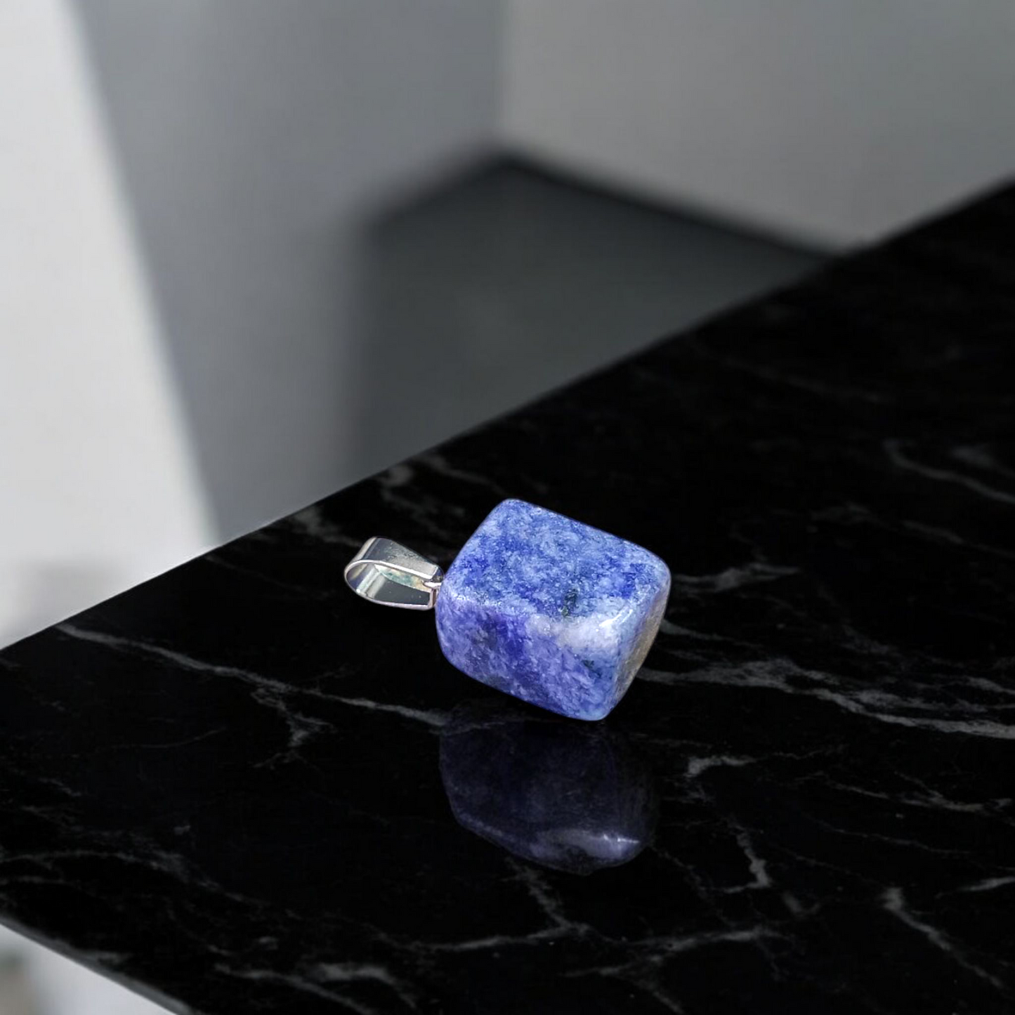 Image of a deep blue Lapis Lazuli Pendant with shimmering golden flecks, attached to a white metal chain – ideal for daily wear and spiritual benefits