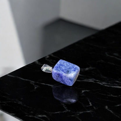 Image of a deep blue Lapis Lazuli Pendant with shimmering golden flecks, attached to a white metal chain – ideal for daily wear and spiritual benefits