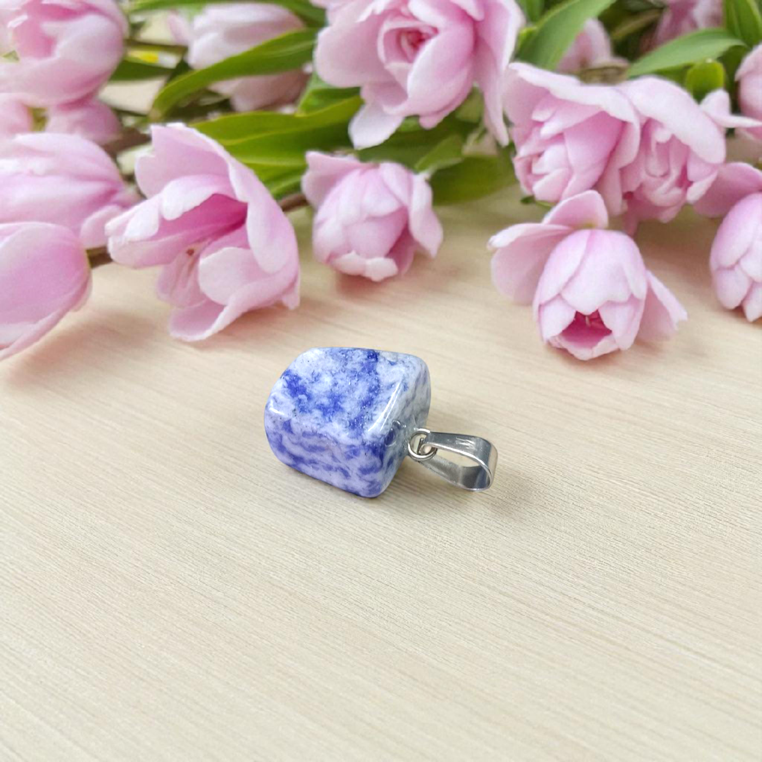 Image of a deep blue Lapis Lazuli Pendant with shimmering golden flecks, attached to a white metal chain – ideal for daily wear and spiritual benefits