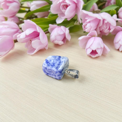 Image of a deep blue Lapis Lazuli Pendant with shimmering golden flecks, attached to a white metal chain – ideal for daily wear and spiritual benefits