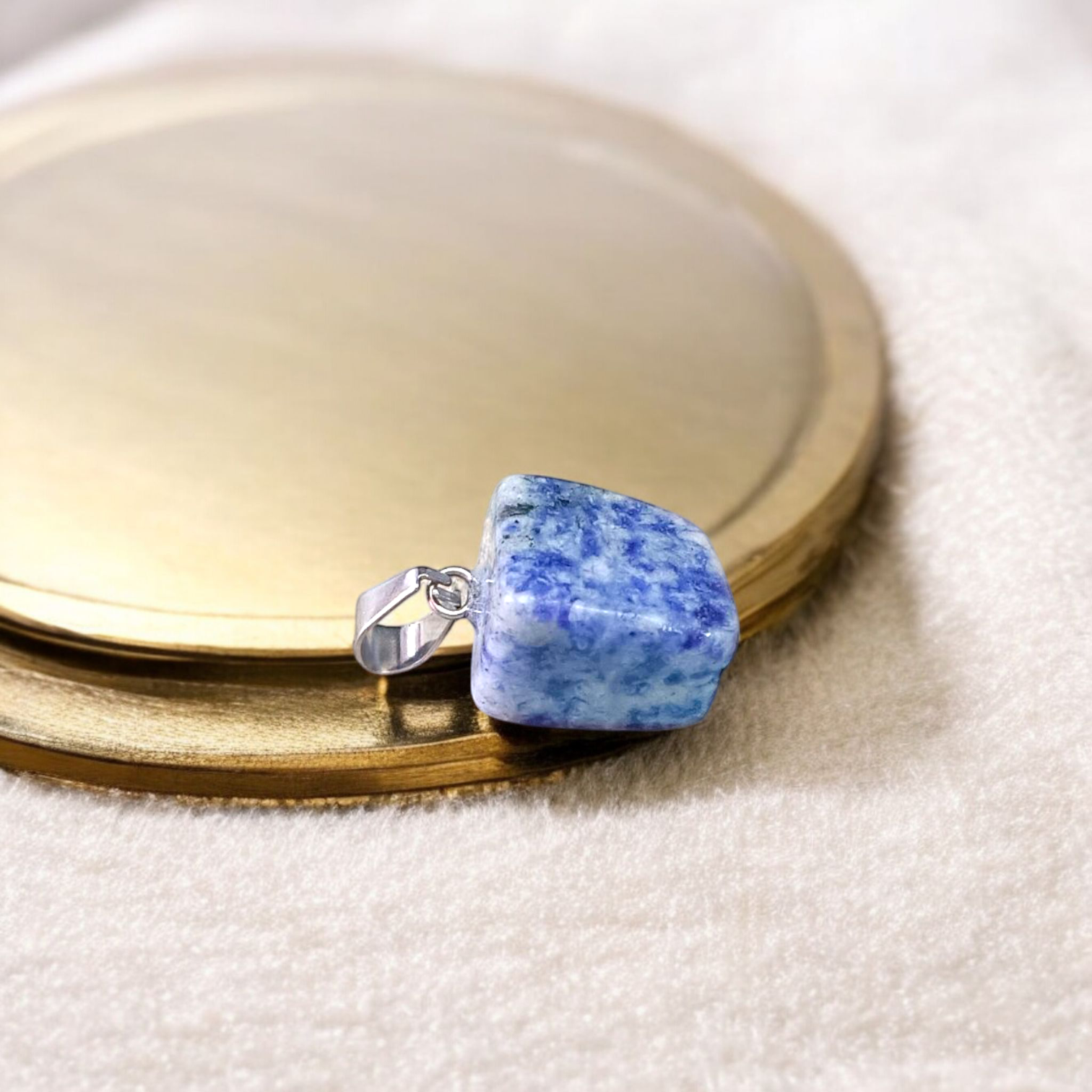 Image of a deep blue Lapis Lazuli Pendant with shimmering golden flecks, attached to a white metal chain – ideal for daily wear and spiritual benefits