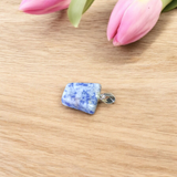 Image of a deep blue Lapis Lazuli Pendant with shimmering golden flecks, attached to a white metal chain – ideal for daily wear and spiritual benefits