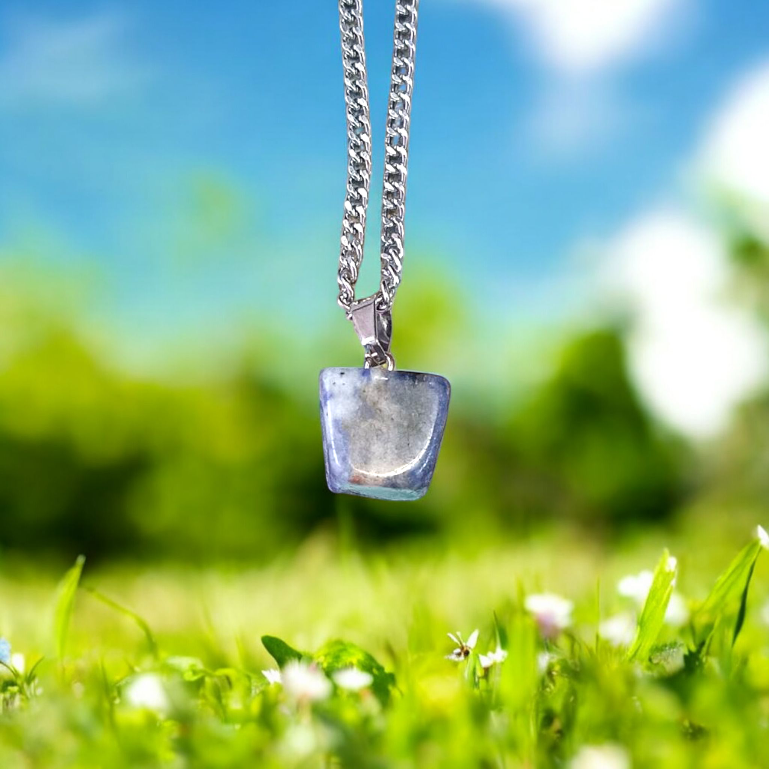 Image of a deep blue Lapis Lazuli Pendant with shimmering golden flecks, attached to a white metal chain – ideal for daily wear and spiritual benefits