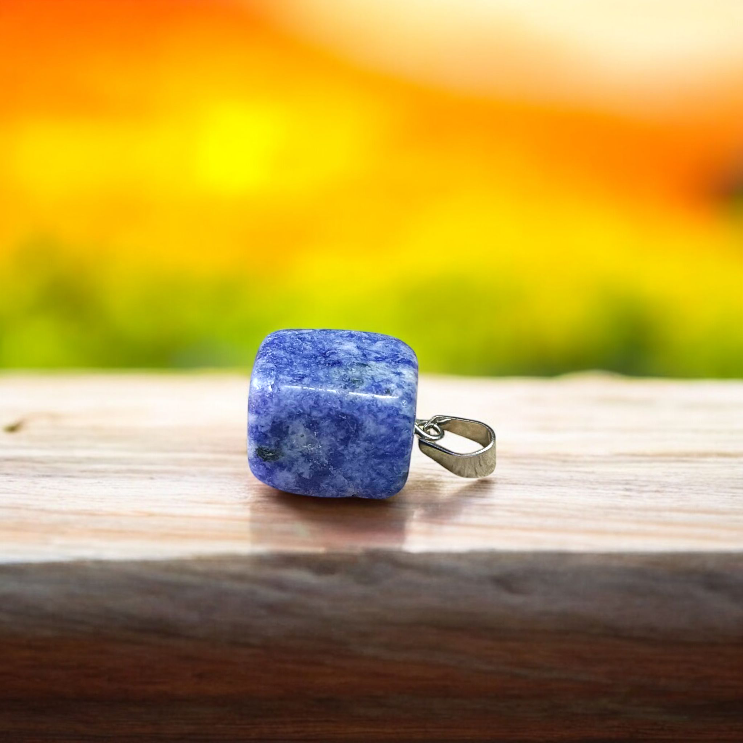 Image of a deep blue Lapis Lazuli Pendant with shimmering golden flecks, attached to a white metal chain – ideal for daily wear and spiritual benefits