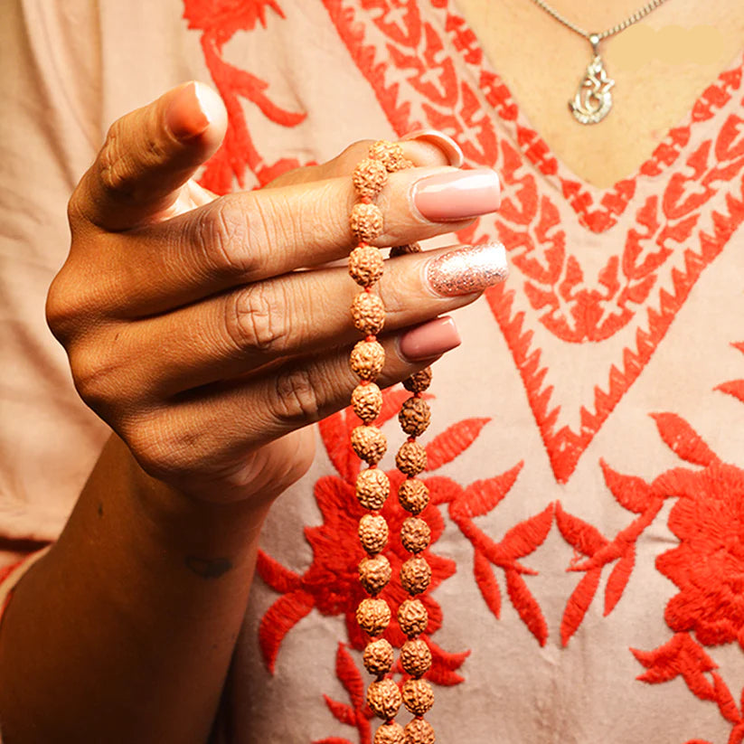 Image of authentic 4 Mukhi Rudraksha Mala in 27+1 and 108+1 bead variants, lab-certified, used for creativity and Guru Pujan.