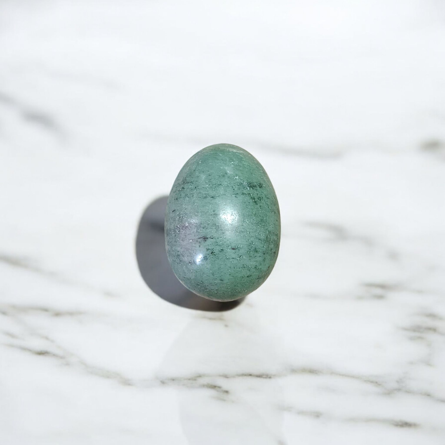 Image of handcrafted greenish black Shivling stone ideal for Tulsi plant, temple, or garden use