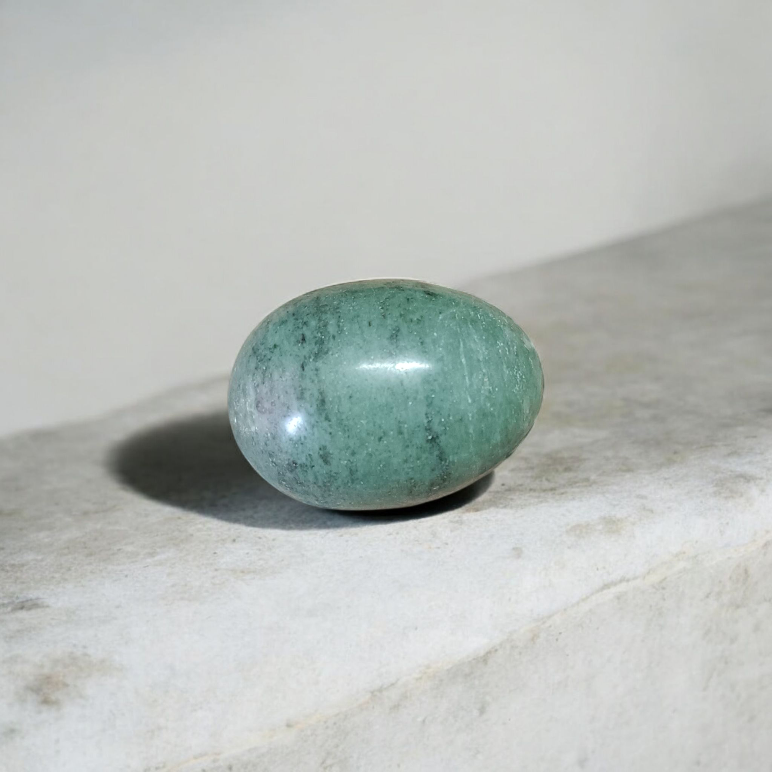 Image of handcrafted greenish black Shivling stone ideal for Tulsi plant, temple, or garden use