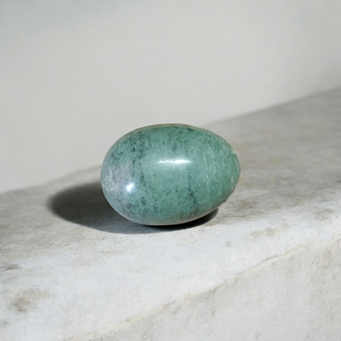 Image of handcrafted greenish black Shivling stone ideal for Tulsi plant, temple, or garden use