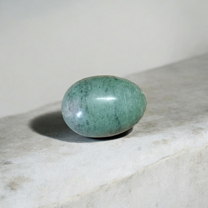 Image of handcrafted greenish black Shivling stone ideal for Tulsi plant, temple, or garden use