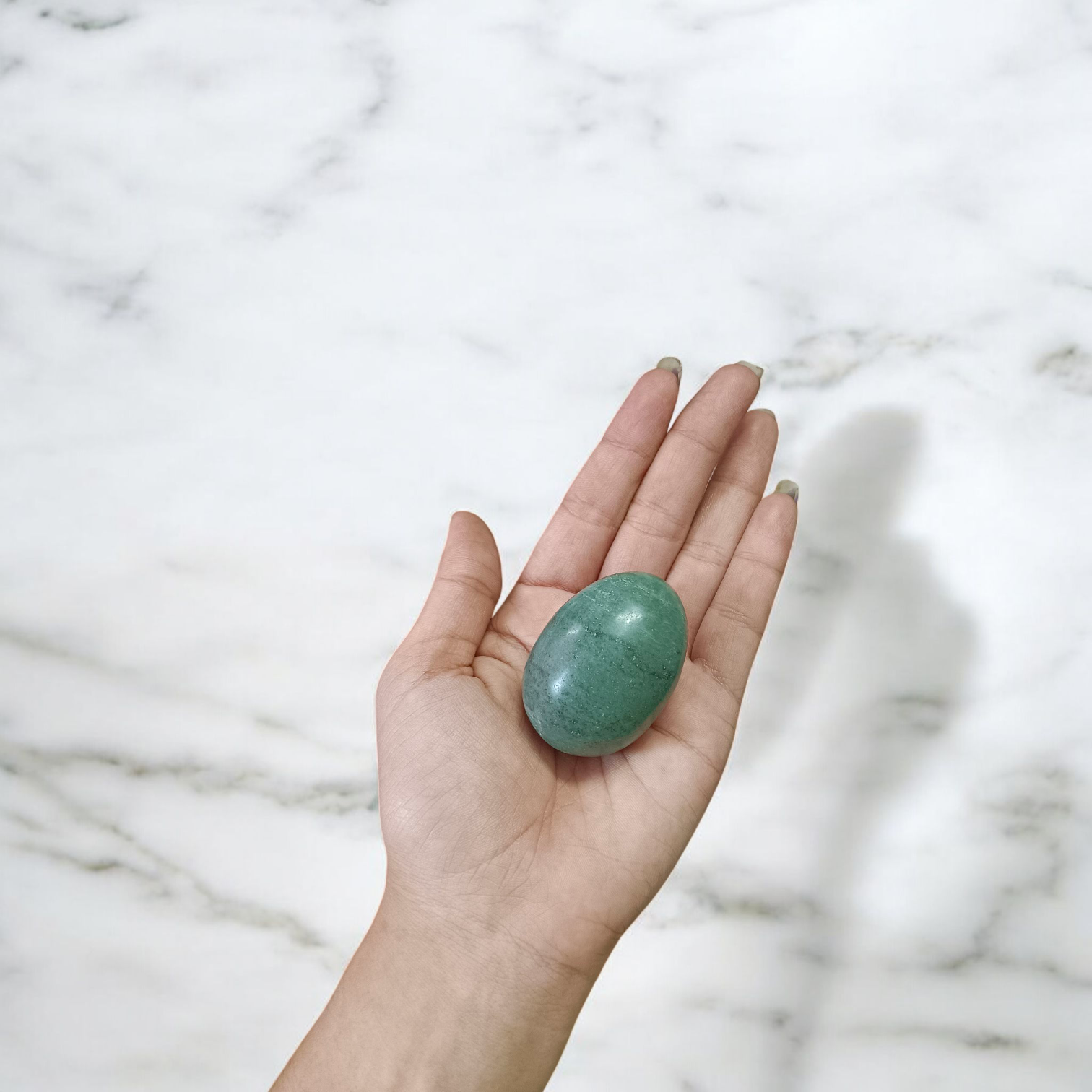 Image of handcrafted greenish black Shivling stone ideal for Tulsi plant, temple, or garden use