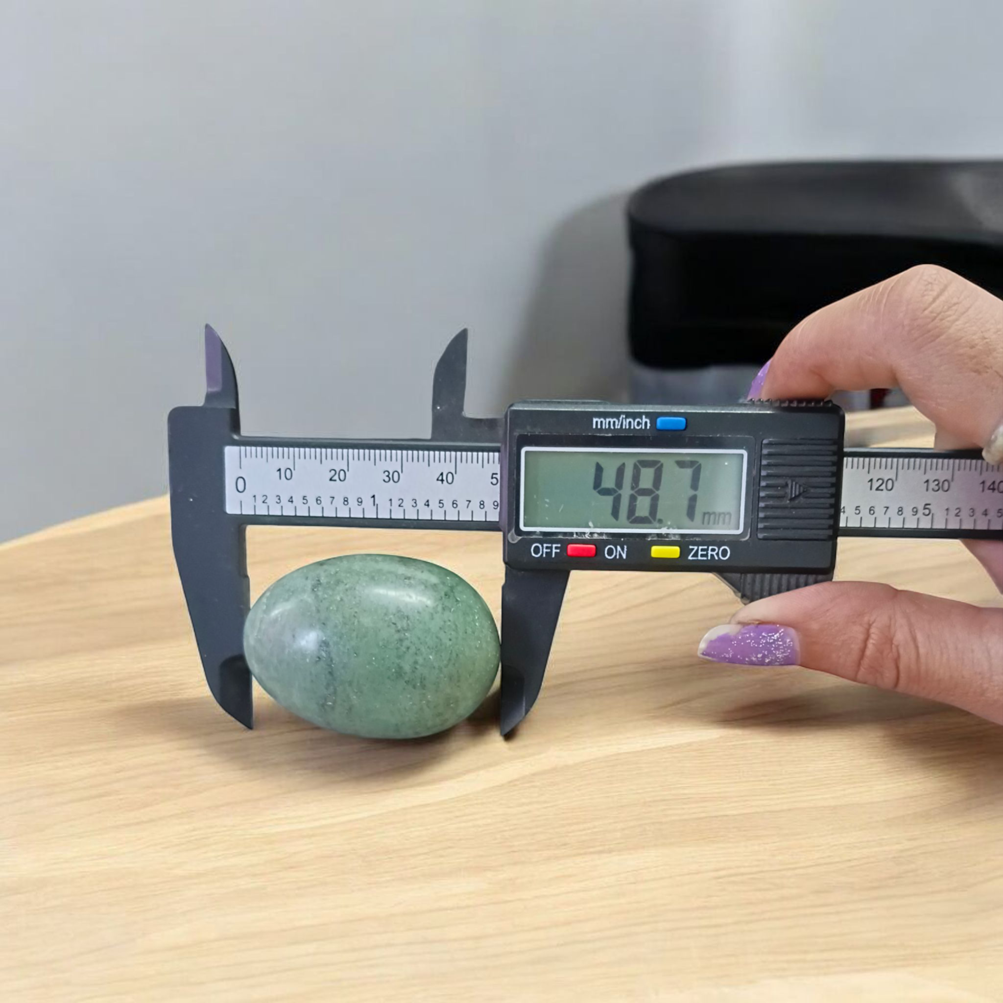 Image of handcrafted greenish black Shivling stone ideal for Tulsi plant, temple, or garden use