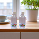 Image of two sealed 100g bottles of Pure Gangajal Holy Water, ideal for puja and spiritual rituals
