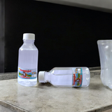 Image of two sealed 100g bottles of Pure Gangajal Holy Water, ideal for puja and spiritual rituals