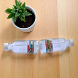 Image of two sealed 100g bottles of Pure Gangajal Holy Water, ideal for puja and spiritual rituals