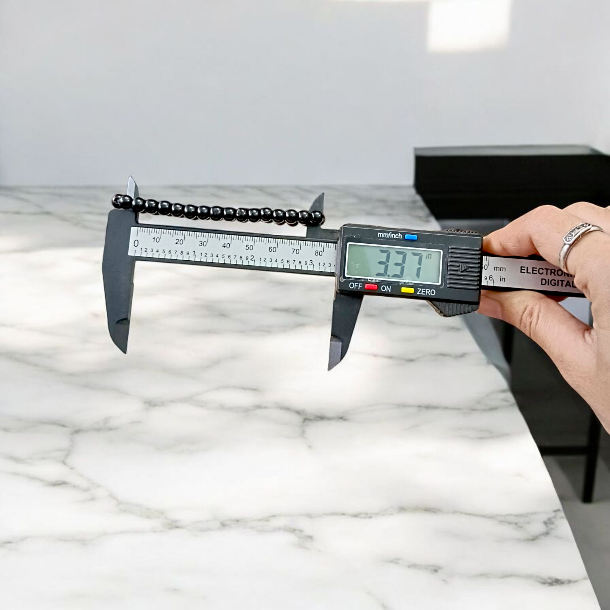 Image showing a premium Natural Black Agate Bracelet made with 6mm smooth round beads on a stretchable elastic band