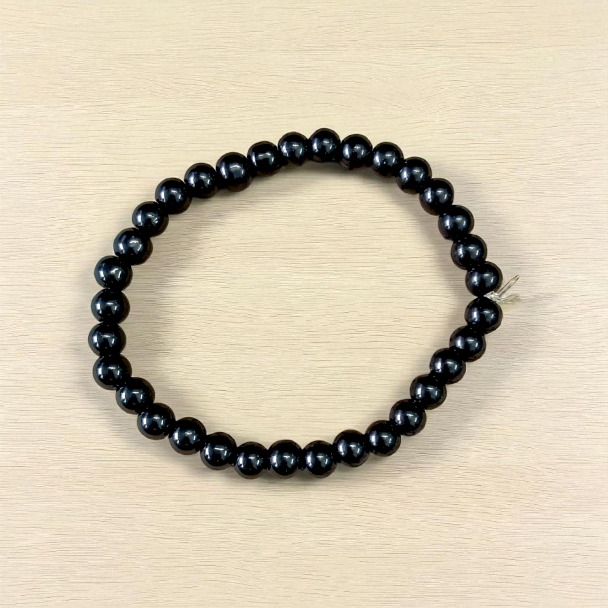 Image showing a premium Natural Black Agate Bracelet made with 6mm smooth round beads on a stretchable elastic band
