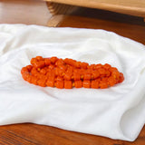 Image showing an energized Orange Monga Mala with 108+1 coral beads, ideal for Mars-related spiritual remedies