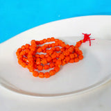 Image showing an energized Orange Monga Mala with 108+1 coral beads, ideal for Mars-related spiritual remedies