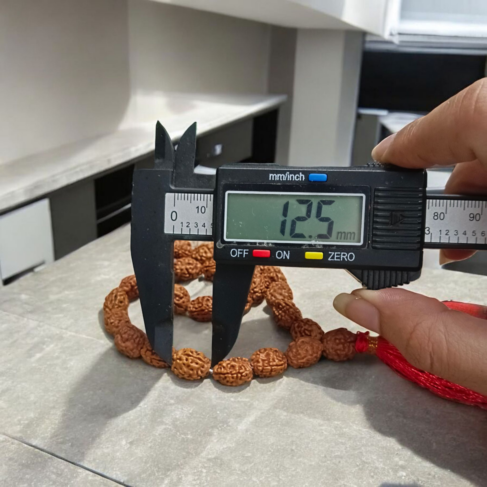 Lab-certified 3 Mukhi Rudraksha Mala for stress and anxiety relief, available in 27+1 and 108+1 bead variants, by Gurupujan