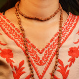 Lab-certified 3 Mukhi Rudraksha Mala for stress and anxiety relief, available in 27+1 and 108+1 bead variants, by Gurupujan.