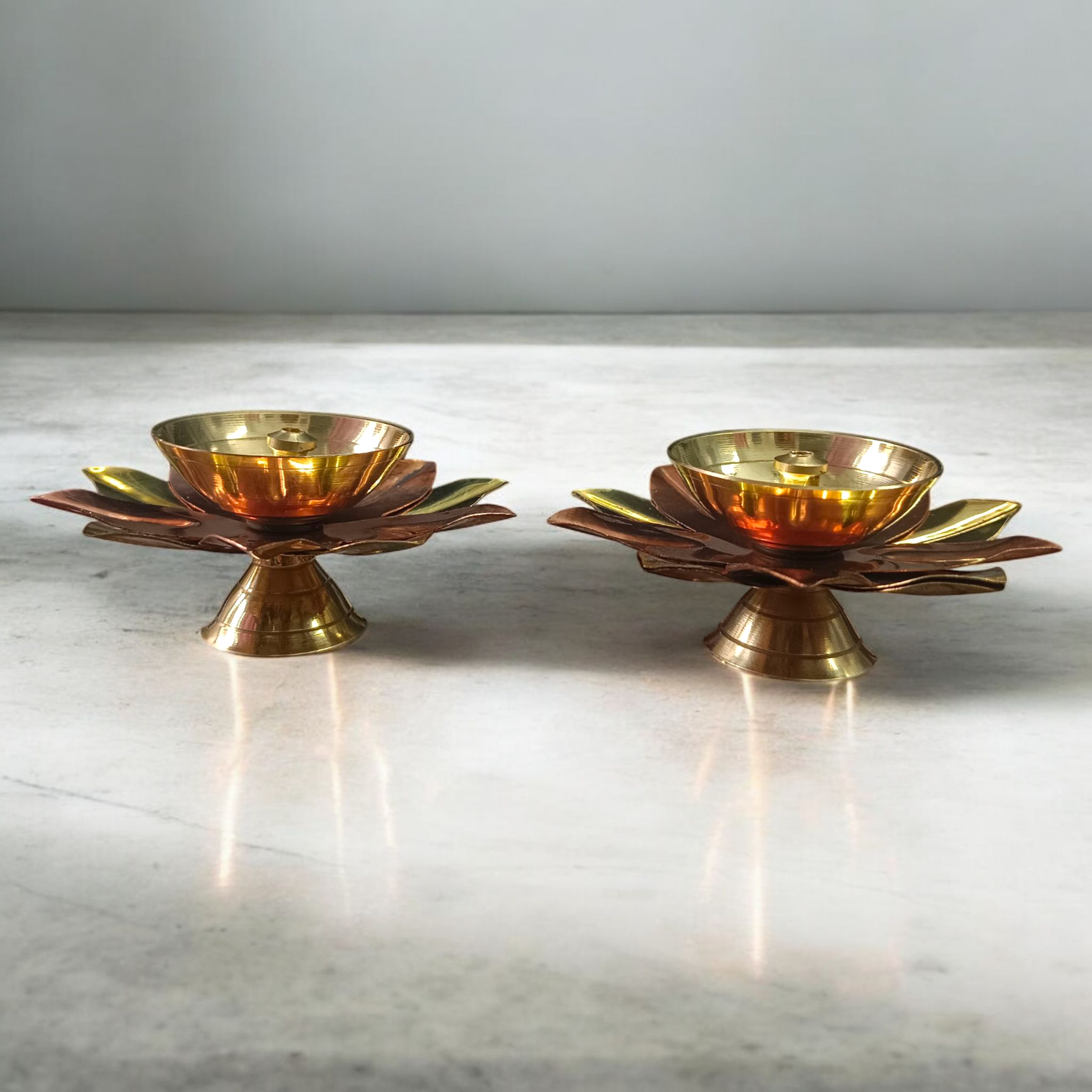 Lotus-shaped Akhand Jyot set of 2 placed in a traditional temple setup, used for pooja and aarti rituals