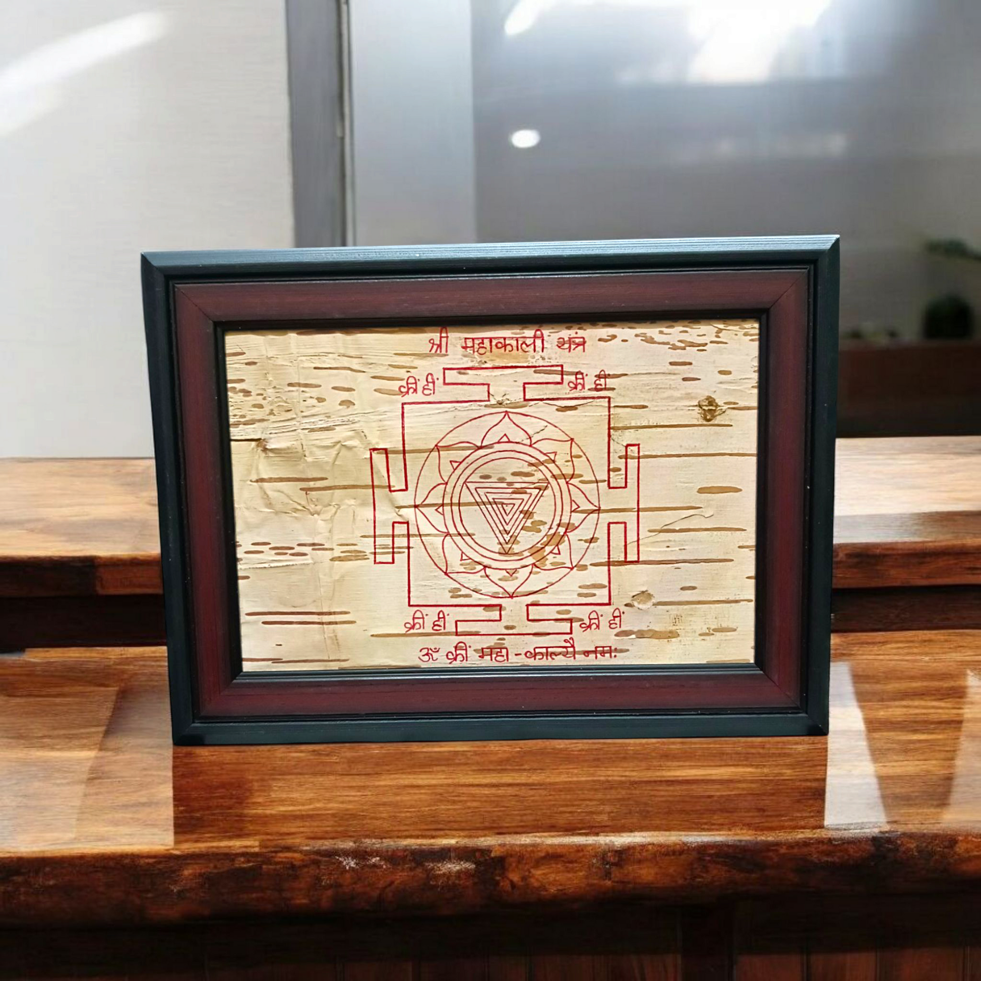 Mahakali Yantra inscribed on Bhojpatra, framed in wood, representing Maa Kali’s divine energy, strength, and protection.