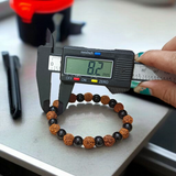Natural Agate and 5 Mukhi Rudraksha Bracelet with 8mm black and brown beads on stretchable thread, lab certified, displayed on a natural stone background