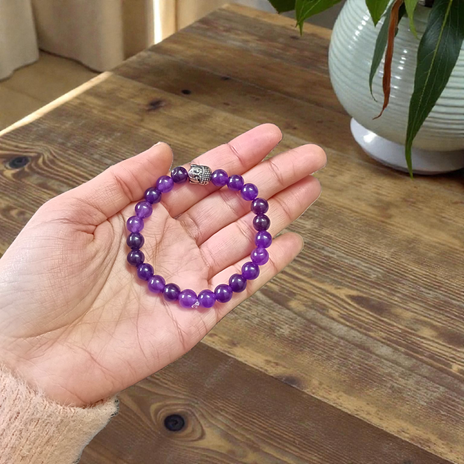 Natural Amethyst Bracelet with polished purple beads, stretchable design, placed on a neutral background