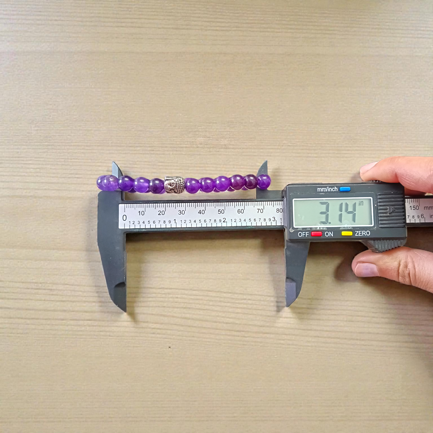 Natural Amethyst Bracelet with polished purple beads, stretchable design, placed on a neutral background