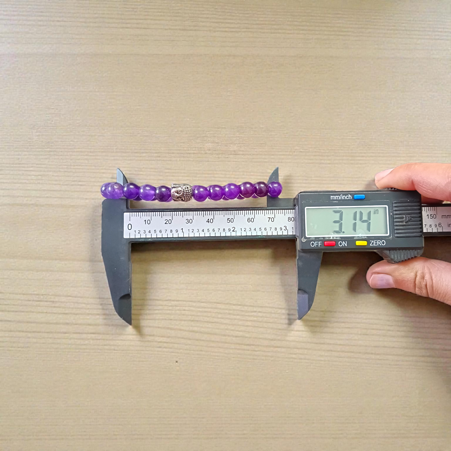 Natural Amethyst Bracelet with polished purple beads, stretchable design, placed on a neutral background