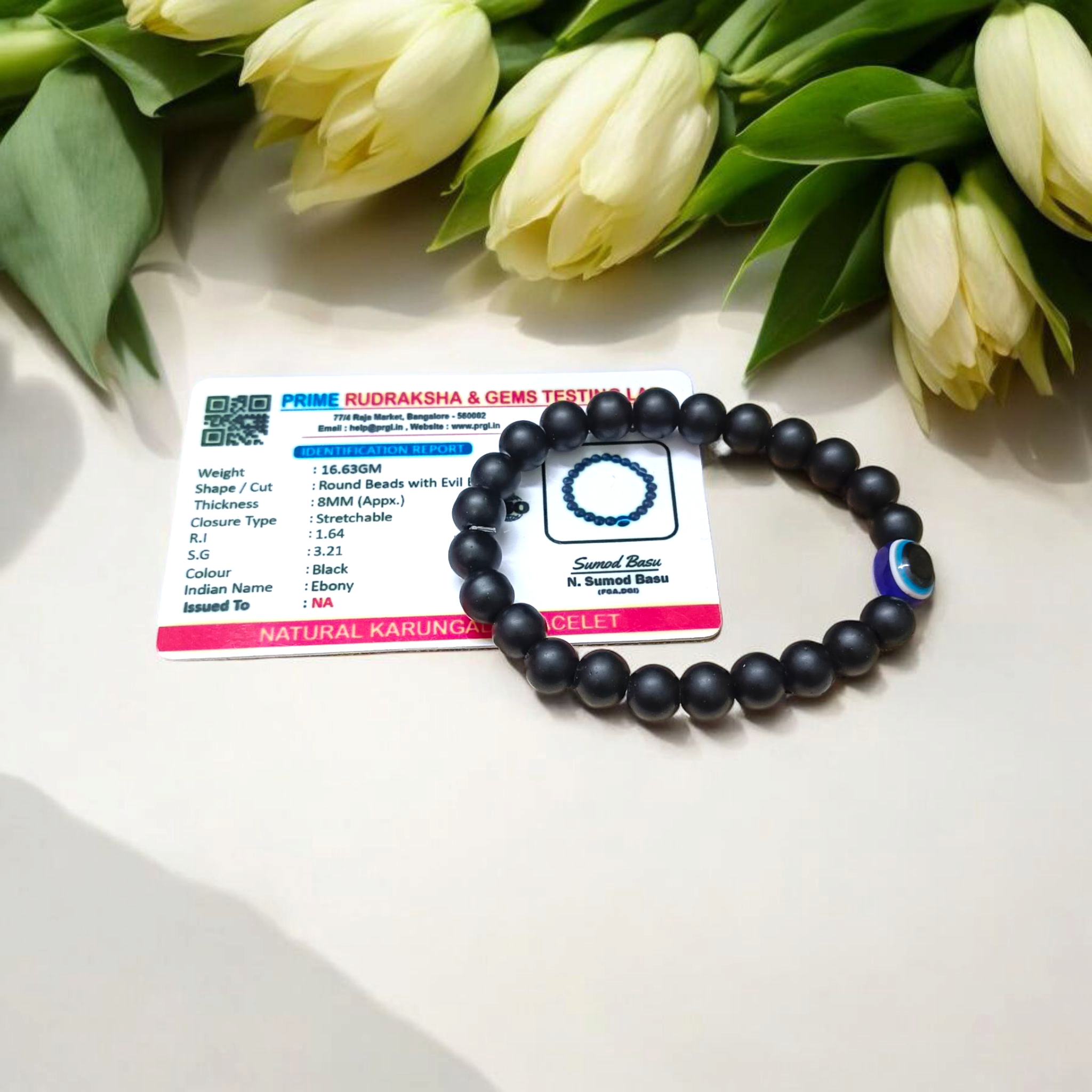Natural Karungali (Ebony Wood) Bracelet with 8mm round beads and a central Evil Eye bead, stretchable and lab certified, displayed on a neutral background
