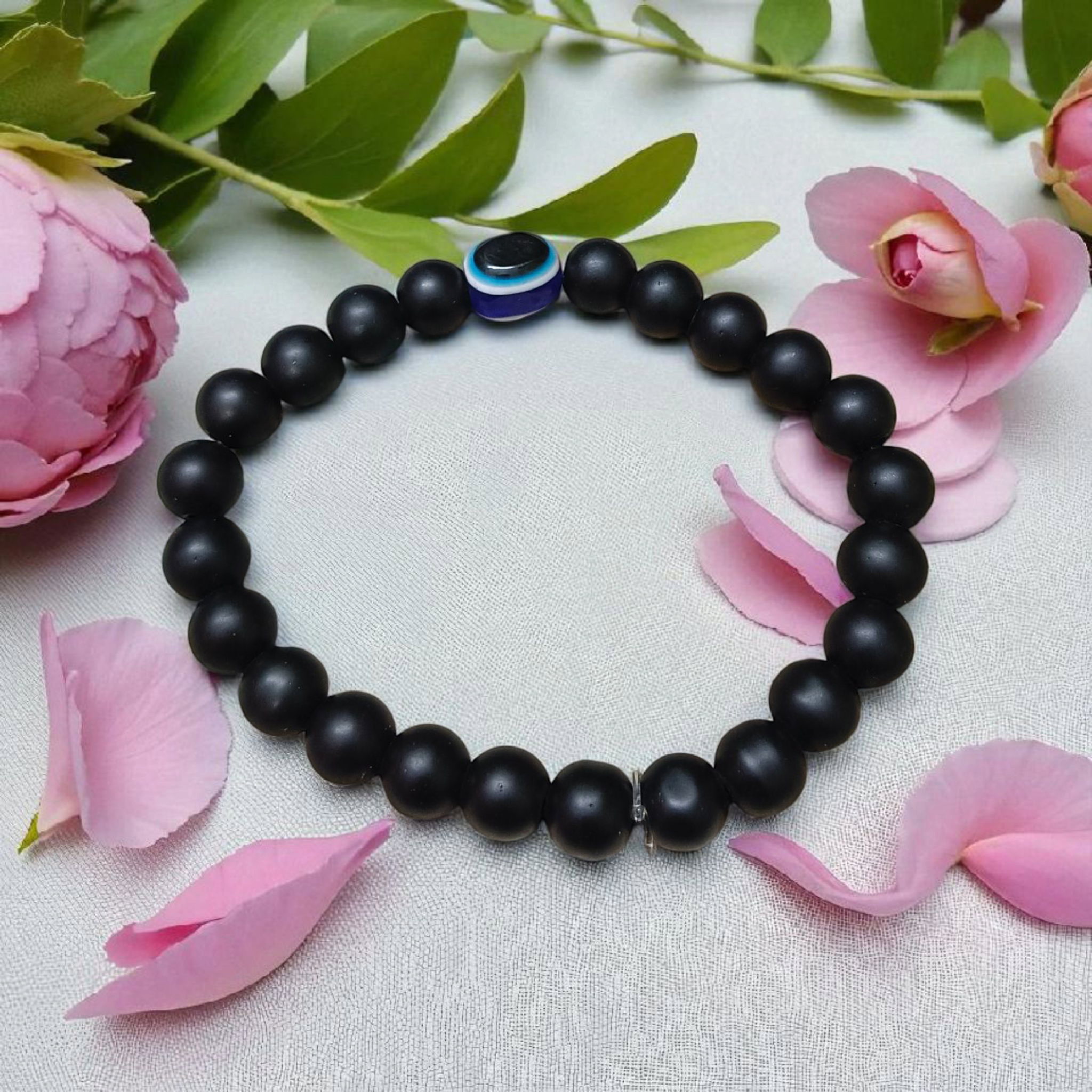 Natural Karungali (Ebony Wood) Bracelet with 8mm round beads and a central Evil Eye bead, stretchable and lab certified, displayed on a neutral background