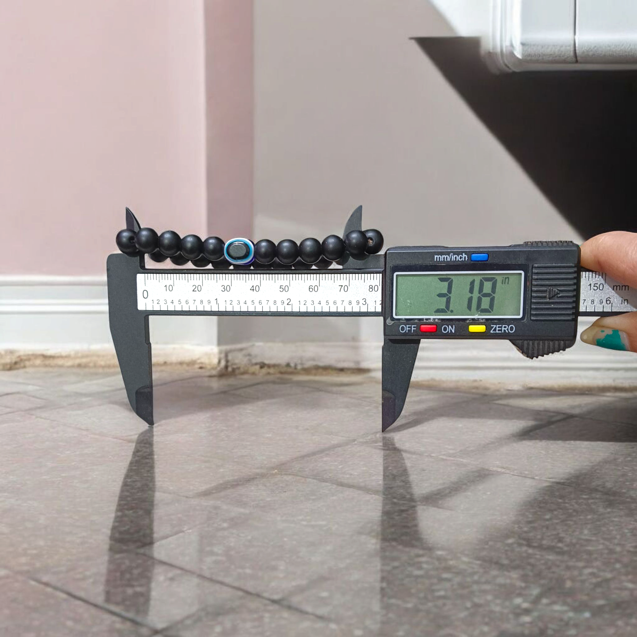 Natural Karungali (Ebony Wood) Bracelet with 8mm round beads and a central Evil Eye bead, stretchable and lab certified, displayed on a neutral background