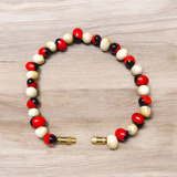 Natural Red and White Gunja bracelet with 5mm lab certified beads on stretchable cord, displayed on a neutral background