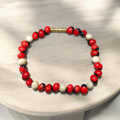 Natural Red and White Gunja seed bracelet with approx. 5mm beads, stretchable and lab certified, displayed on a white background