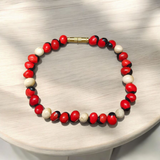 Natural Red and White Gunja seed bracelet with approx. 5mm beads, stretchable and lab certified, displayed on a white background